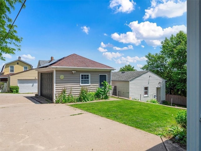 224 Bronx Ave, West View, PA 15229 - view of front of home featuring a detached garage, solar panels, and an outdoor structure