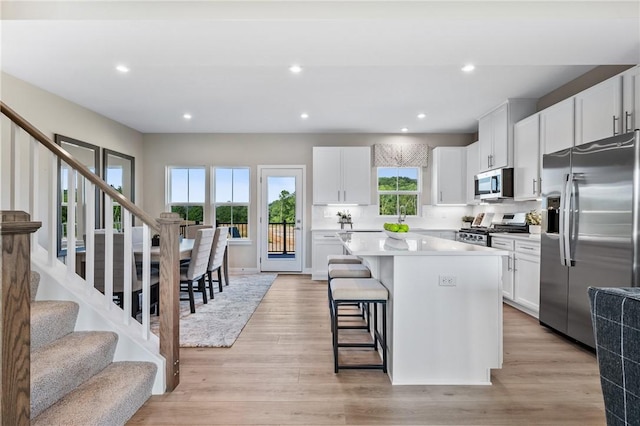 214 Hunter Dr, Moon/Crescent Twp, PA 15108 - kitchen featuring stainless steel appliances, a kitchen island, a breakfast bar, white cabinetry, and recessed lighting
