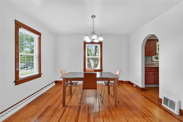 1605 Maratta Rd, Hopewell Twp, PA 15001 - dining space with a baseboard radiator, arched walkways, light wood finished floors, and a chandelier