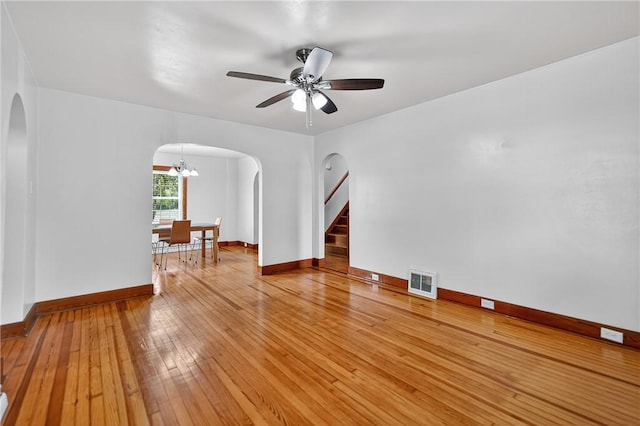 1605 Maratta Rd, Hopewell Twp, PA 15001 - unfurnished room with arched walkways, a ceiling fan, light wood finished floors, and stairs