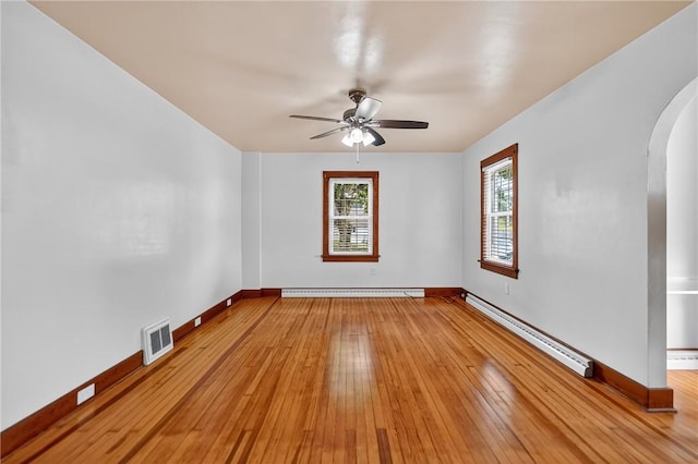 1605 Maratta Rd, Hopewell Twp, PA 15001 - spare room featuring a baseboard radiator, arched walkways, ceiling fan, and light wood-type flooring