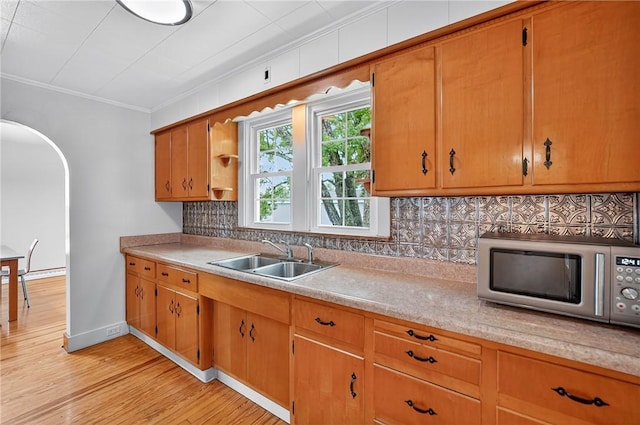 1605 Maratta Rd, Hopewell Twp, PA 15001 - kitchen with stainless steel microwave, light countertops, arched walkways, crown molding, and light wood-style floors