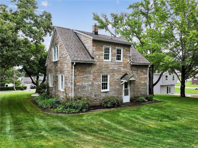 1605 Maratta Rd, Hopewell Twp, PA 15001 - back of property with stone siding, a chimney, roof with shingles, and a lawn