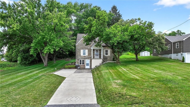 1605 Maratta Rd, Hopewell Twp, PA 15001 - view of front facade with stone siding, a front yard, and a storage shed
