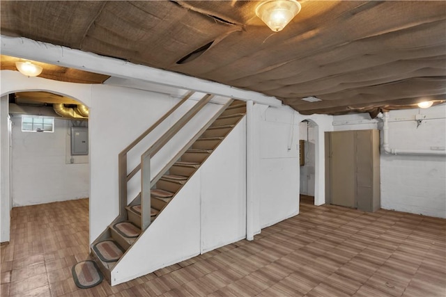 1255 Park Pl, Beaver, PA 15009 - below grade area featuring electric panel, tile patterned floors, arched walkways, and stairs