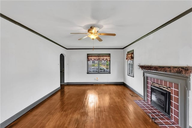 1255 Park Pl, Beaver, PA 15009 - unfurnished living room with a fireplace, arched walkways, wood finished floors, ceiling fan, and crown molding