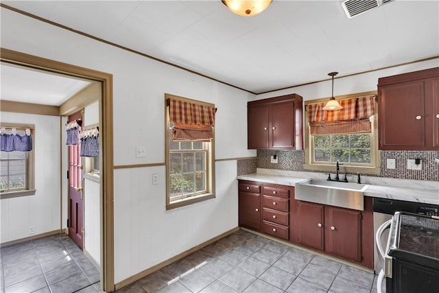 1255 Park Pl, Beaver, PA 15009 - kitchen featuring dishwashing machine, light tile patterned floors, pendant lighting, a wainscoted wall, and tasteful backsplash