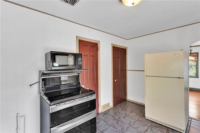 1255 Park Pl, Beaver, PA 15009 - kitchen featuring freestanding refrigerator, double oven range, black microwave, and tile patterned flooring