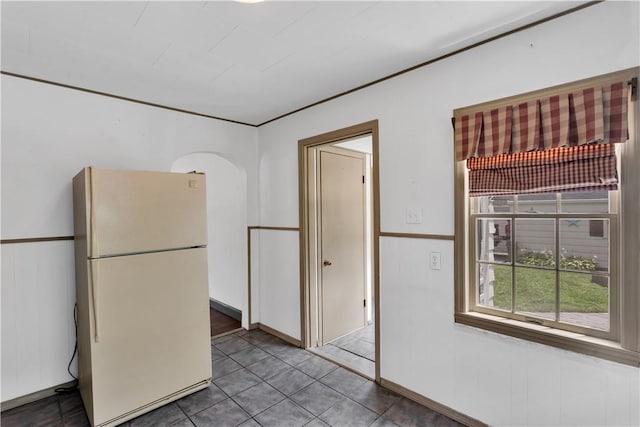 1255 Park Pl, Beaver, PA 15009 - kitchen with freestanding refrigerator, arched walkways, and tile patterned flooring