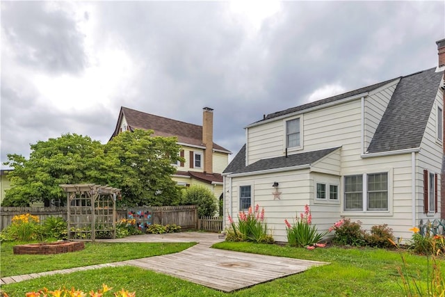 1255 Park Pl, Beaver, PA 15009 - back of property featuring a shingled roof, a chimney, and a patio area