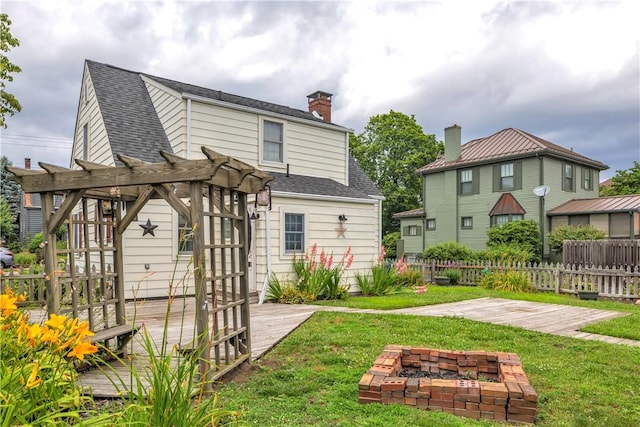 1255 Park Pl, Beaver, PA 15009 - back of property with an outdoor fire pit, a wooden deck, a chimney, and roof with shingles