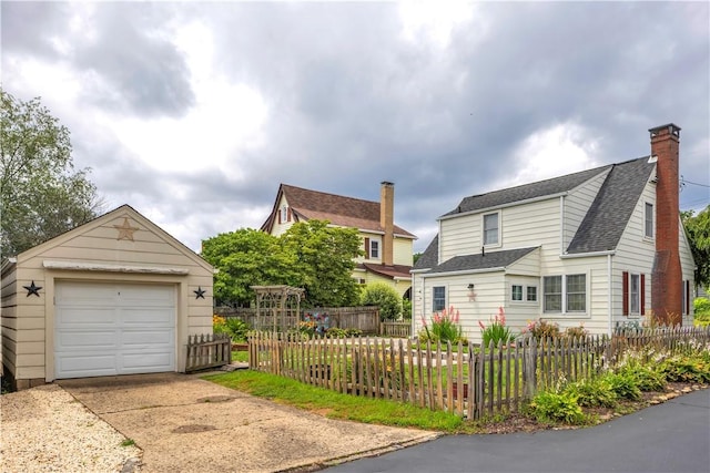 1255 Park Pl, Beaver, PA 15009 - view of side of property featuring driveway, a shingled roof, a chimney, a detached garage, and an outbuilding
