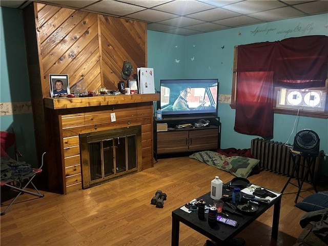 1175 New Salem Rd, Menallen Twp, PA 15468 - living area with a glass covered fireplace, a drop ceiling, wood finished floors, and radiator