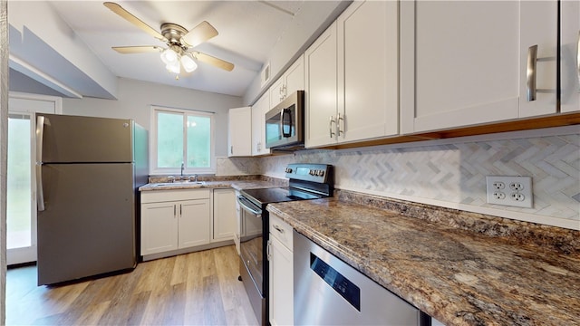 120 Rivermont Ct, Harmar, PA 15024 - kitchen featuring appliances with stainless steel finishes, dark stone countertops, white cabinetry, light wood-type flooring, and tasteful backsplash