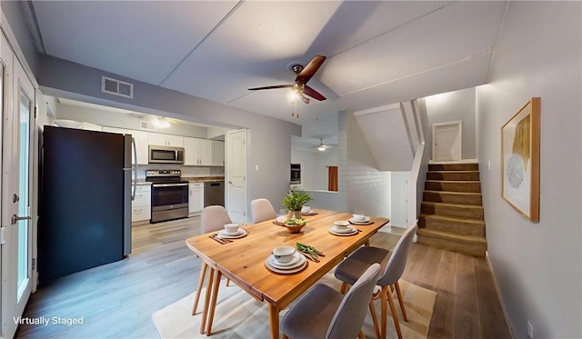 120 Rivermont Ct, Harmar, PA 15024 - dining room featuring ceiling fan, light wood-style flooring, and stairway