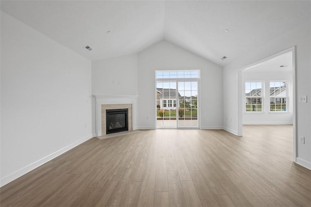 1082 Forest Oaks Dr, Center Twp, PA 16001 - unfurnished living room featuring plenty of natural light, a tiled fireplace, wood finished floors, and lofted ceiling