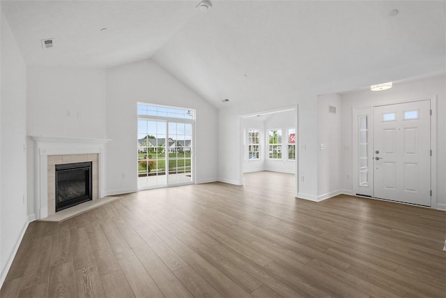 1082 Forest Oaks Dr, Center Twp, PA 16001 - unfurnished living room with wood finished floors, a tile fireplace, and high vaulted ceiling