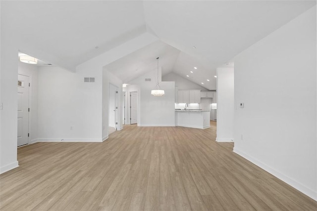 1082 Forest Oaks Dr, Center Twp, PA 16001 - unfurnished living room with light wood finished floors, vaulted ceiling, and recessed lighting