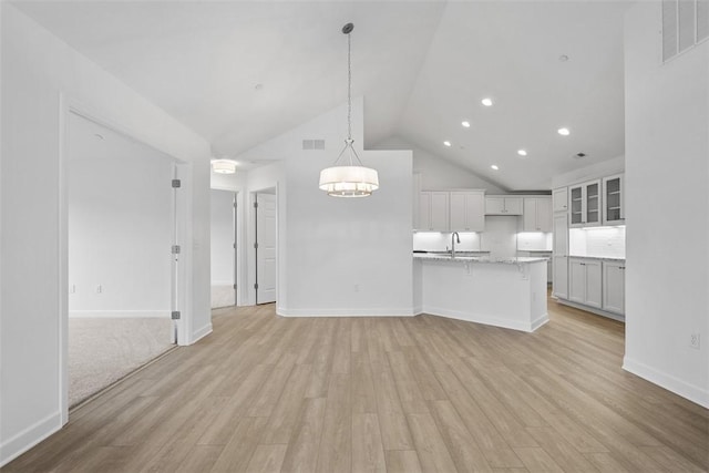1082 Forest Oaks Dr, Center Twp, PA 16001 - unfurnished living room featuring light wood finished floors, high vaulted ceiling, a chandelier, and recessed lighting
