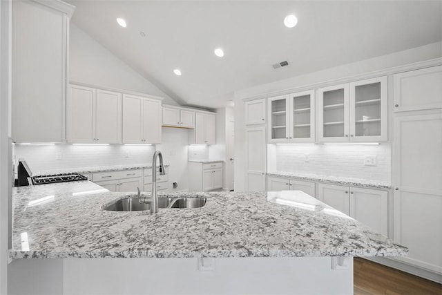 1082 Forest Oaks Dr, Center Twp, PA 16001 - kitchen with a peninsula, white cabinetry, light stone counters, glass insert cabinets, and tasteful backsplash