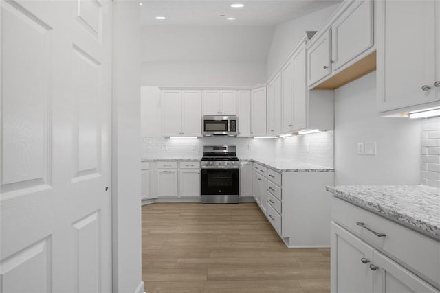 1082 Forest Oaks Dr, Center Twp, PA 16001 - kitchen with stainless steel appliances, tasteful backsplash, white cabinets, light stone countertops, and recessed lighting
