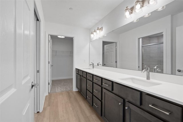 1082 Forest Oaks Dr, Center Twp, PA 16001 - full bath featuring double vanity, a shower stall, wood finished floors, and a walk in closet