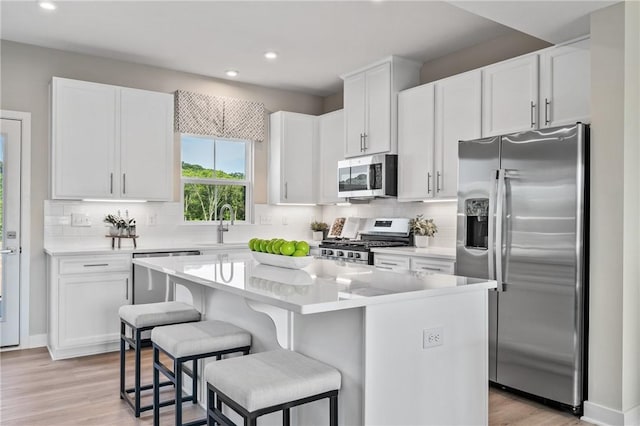 180 Elk Ridge Dr, Moon/Crescent Twp, PA 15108 - kitchen featuring appliances with stainless steel finishes, recessed lighting, a center island, white cabinets, and decorative backsplash