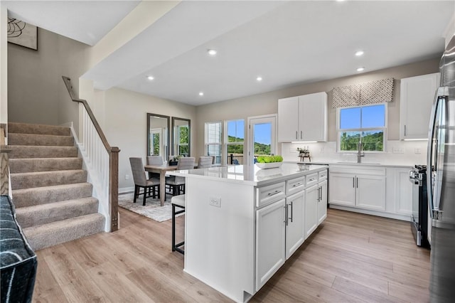 180 Elk Ridge Dr, Moon/Crescent Twp, PA 15108 - kitchen with healthy amount of natural light, white cabinetry, a breakfast bar area, and recessed lighting
