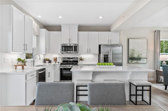 180 Elk Ridge Dr, Moon/Crescent Twp, PA 15108 - kitchen featuring stainless steel appliances, white cabinetry, light countertops, a kitchen island, and recessed lighting