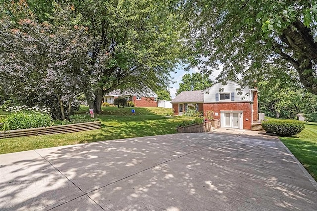 119 S Patton, Moon/Crescent Twp, PA 15108 - tri-level home featuring driveway, brick siding, and a front yard