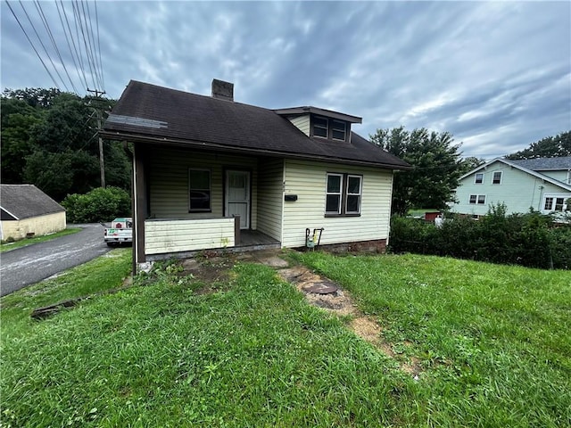 401 N Main St, Chartiers, PA 15342 - view of front of home featuring covered porch, a chimney, and a front lawn
