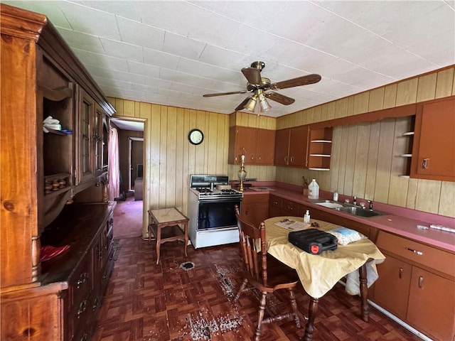 69 Beech St, Cecil, PA 15350 - kitchen with open shelves, gas range gas stove, wood walls, and ceiling fan