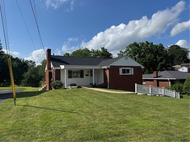 118 Manchester Dr, Hempfield Twp, PA 15642 - view of front of home featuring a chimney, a front lawn, and brick siding