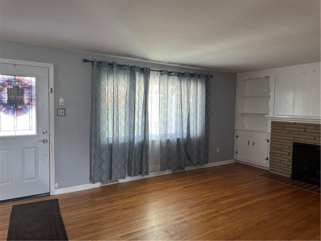 118 Manchester Dr, Hempfield Twp, PA 15642 - unfurnished living room with wood finished floors and a stone fireplace