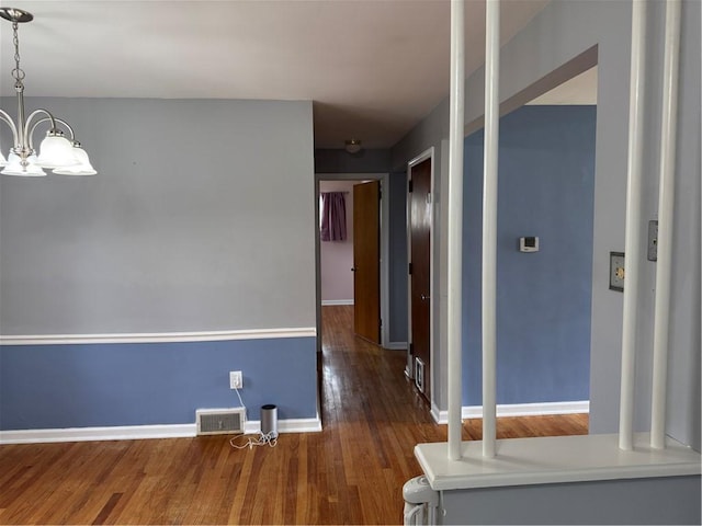 118 Manchester Dr, Hempfield Twp, PA 15642 - empty room with a chandelier and wood finished floors