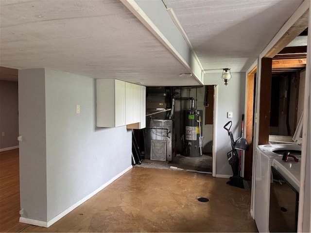 118 Manchester Dr, Hempfield Twp, PA 15642 - kitchen with washer and dryer, water heater, white cabinetry, and heating unit