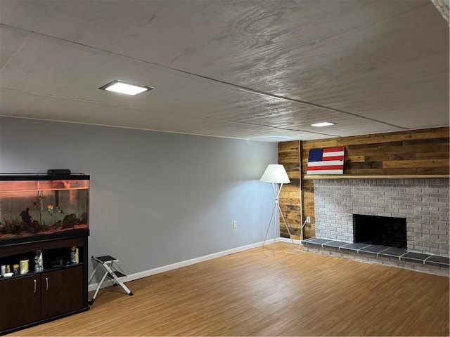 118 Manchester Dr, Hempfield Twp, PA 15642 - unfurnished living room with wood finished floors, wood walls, and a fireplace