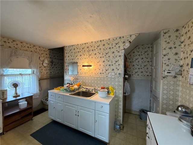 66 Beech St, Cecil, PA 15350 - kitchen featuring wallpapered walls, light countertops, white cabinetry, and light floors