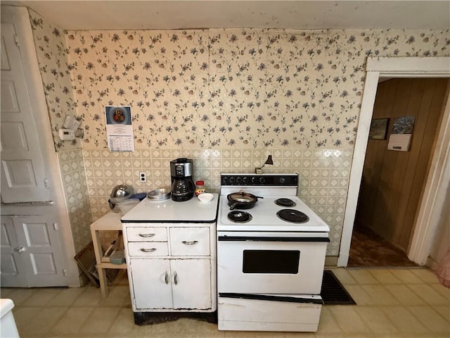 66 Beech St, Cecil, PA 15350 - kitchen featuring electric range, wallpapered walls, light countertops, and light tile patterned flooring