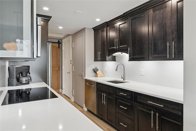 320 Fort Duquesne Blvd Unit 23L, Downtown Pgh, PA 15222 - kitchen featuring stainless steel dishwasher, light countertops, black electric stovetop, a barn door, and recessed lighting