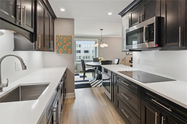 320 Fort Duquesne Blvd Unit 23L, Downtown Pgh, PA 15222 - kitchen with stainless steel appliances, light countertops, recessed lighting, pendant lighting, and light wood-style floors