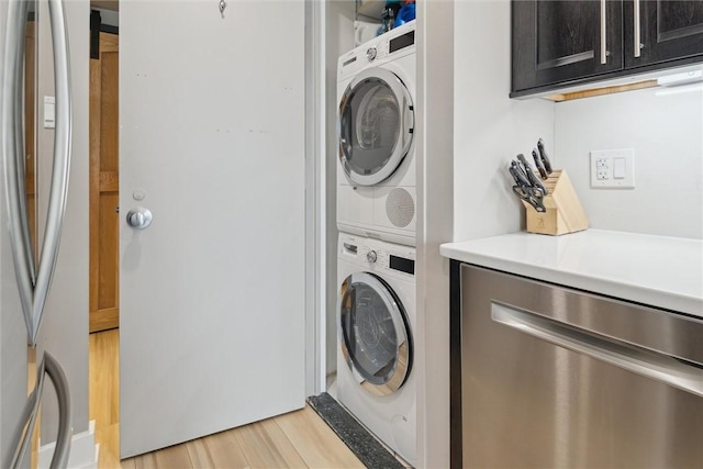 320 Fort Duquesne Blvd Unit 23L, Downtown Pgh, PA 15222 - laundry area featuring stacked washing machine and dryer and light wood-style flooring