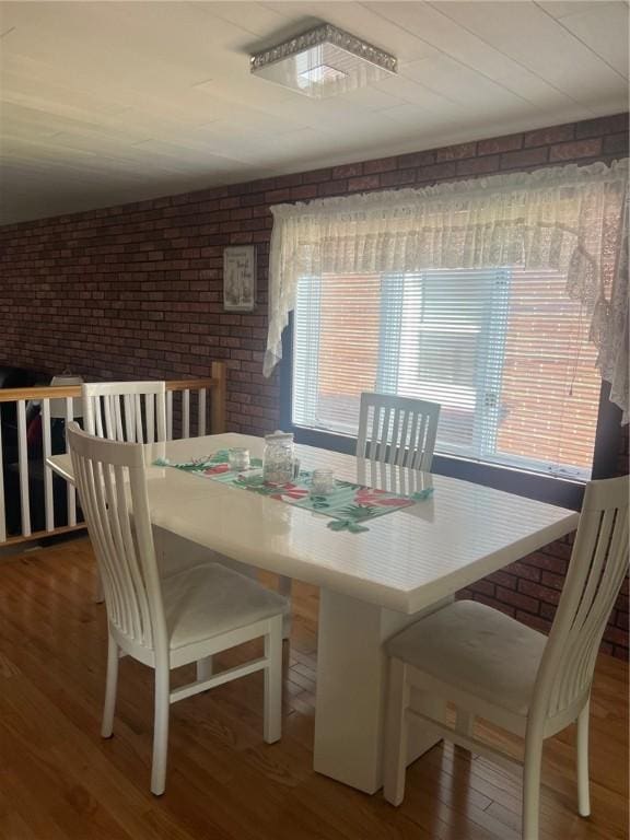 4619 5th Ave, Beaver Falls, PA 15010 - dining space with brick wall, wood finished floors, and plenty of natural light