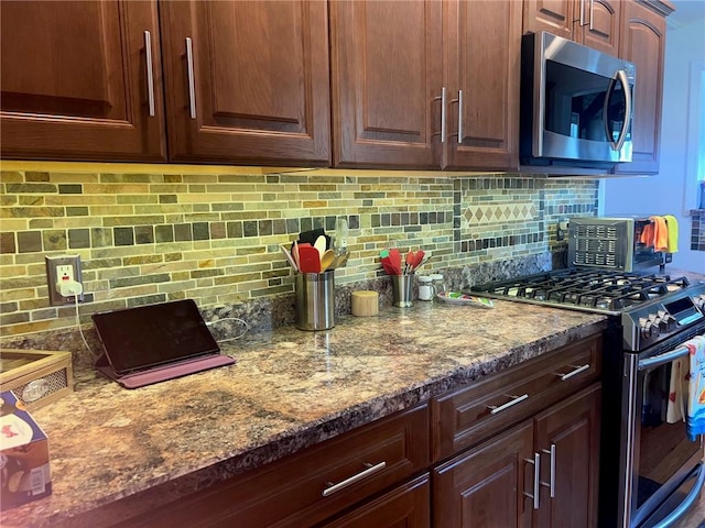 4619 5th Ave, Beaver Falls, PA 15010 - kitchen featuring stainless steel appliances, tasteful backsplash, and dark stone counters