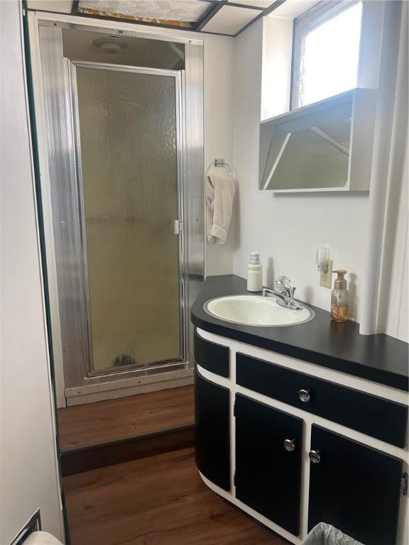 4619 5th Ave, Beaver Falls, PA 15010 - bathroom featuring vanity, a shower stall, and wood finished floors