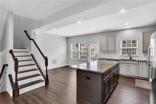 222 Amon St, Cranberry Twp, PA 16066 - kitchen featuring freestanding refrigerator, a kitchen island, dark wood-style floors, light stone counters, and recessed lighting