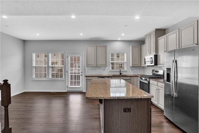222 Amon St, Cranberry Twp, PA 16066 - kitchen featuring stainless steel appliances, a kitchen island, tasteful backsplash, light stone countertops, and dark wood-style floors