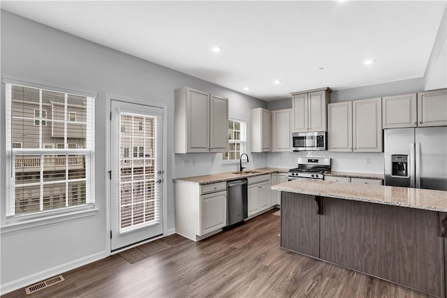 222 Amon St, Cranberry Twp, PA 16066 - kitchen featuring appliances with stainless steel finishes, dark wood-type flooring, a kitchen bar, light stone countertops, and recessed lighting