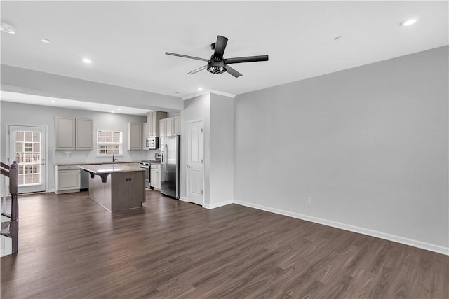 222 Amon St, Cranberry Twp, PA 16066 - kitchen with stainless steel appliances, a kitchen island, a ceiling fan, light countertops, and dark wood-style flooring