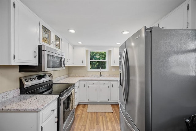 723 Rose Ln, Baldwin Twp, PA 15234 - kitchen with appliances with stainless steel finishes, light wood-style floors, white cabinets, and recessed lighting